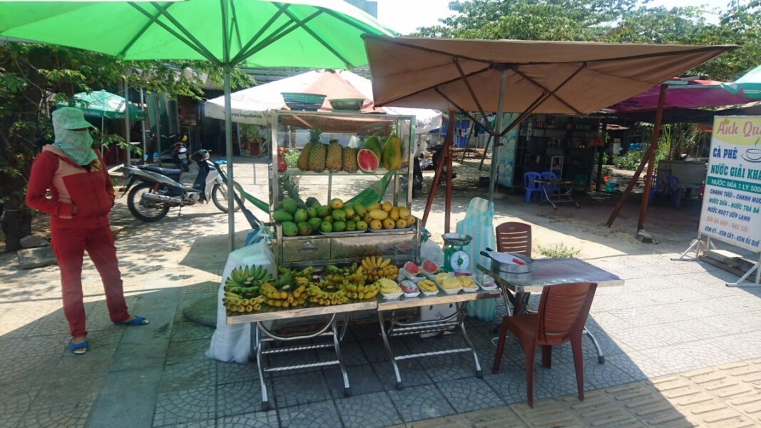 A street trader taking no chances with exposure to the sun